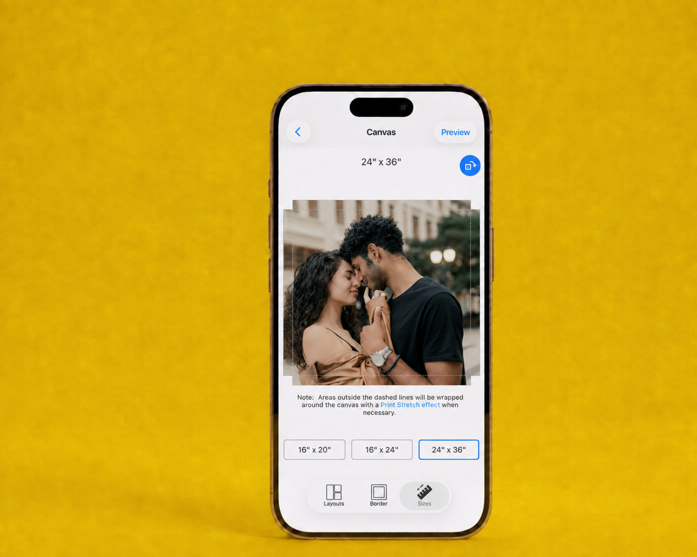 The SimplePrints app on a phone, sizing a couple’s photo for a 24×36 canvas