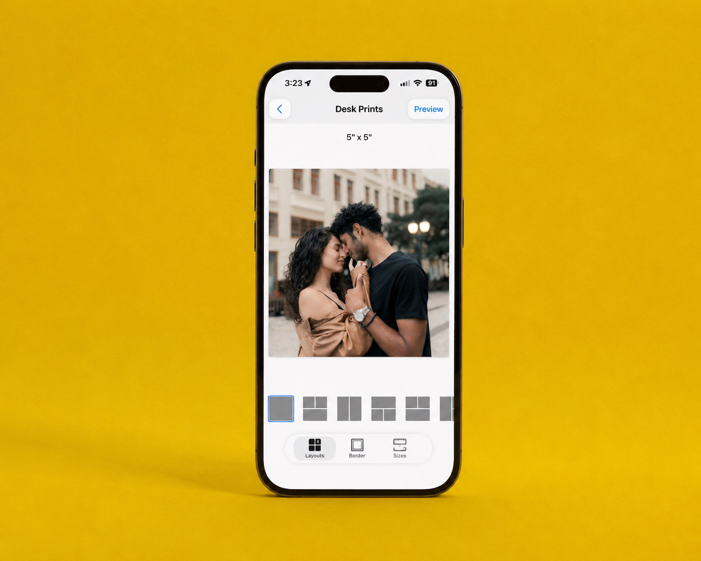 The SimplePrints app on a phone, previewing a couple’s photo as a desk print