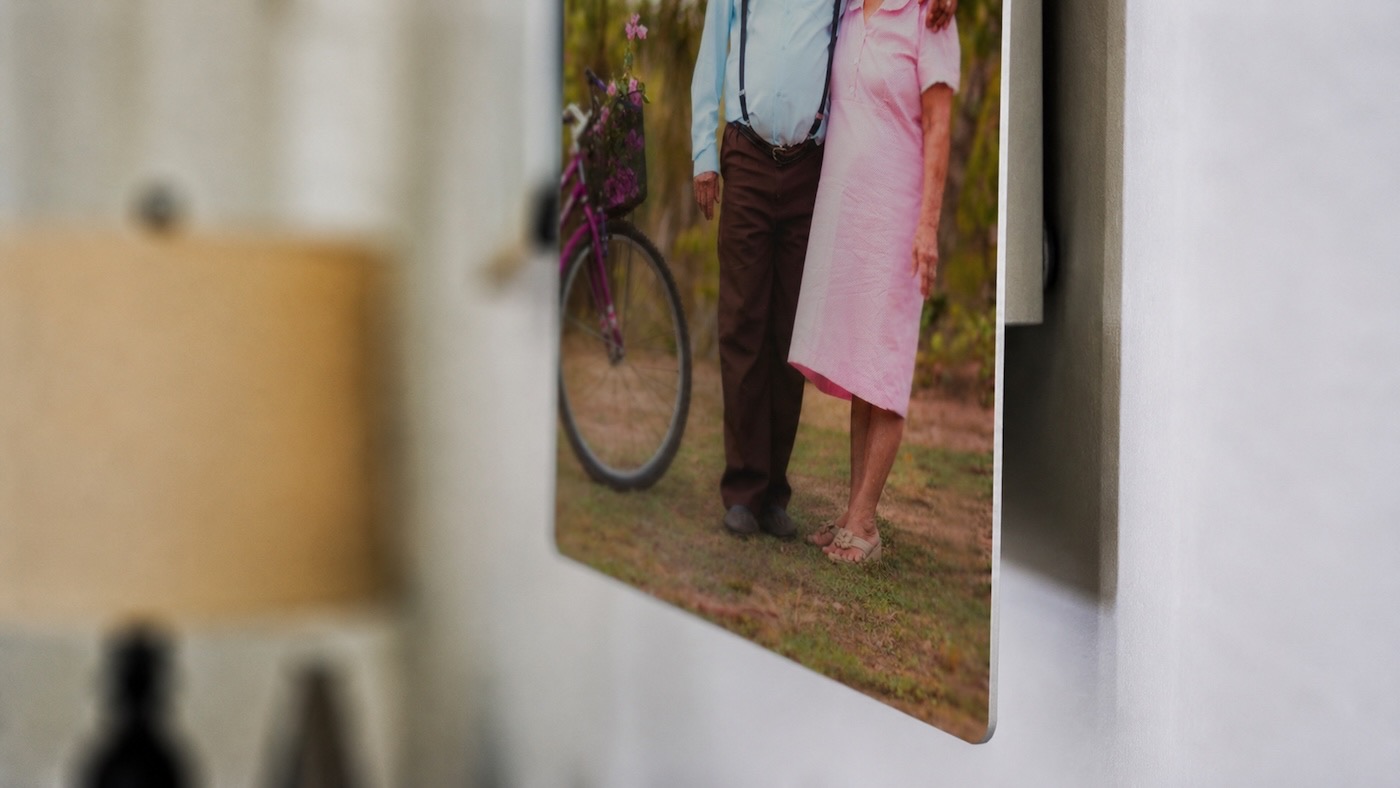 Close-up of a metal print of an older couple floating off the wall on its recessed float mount