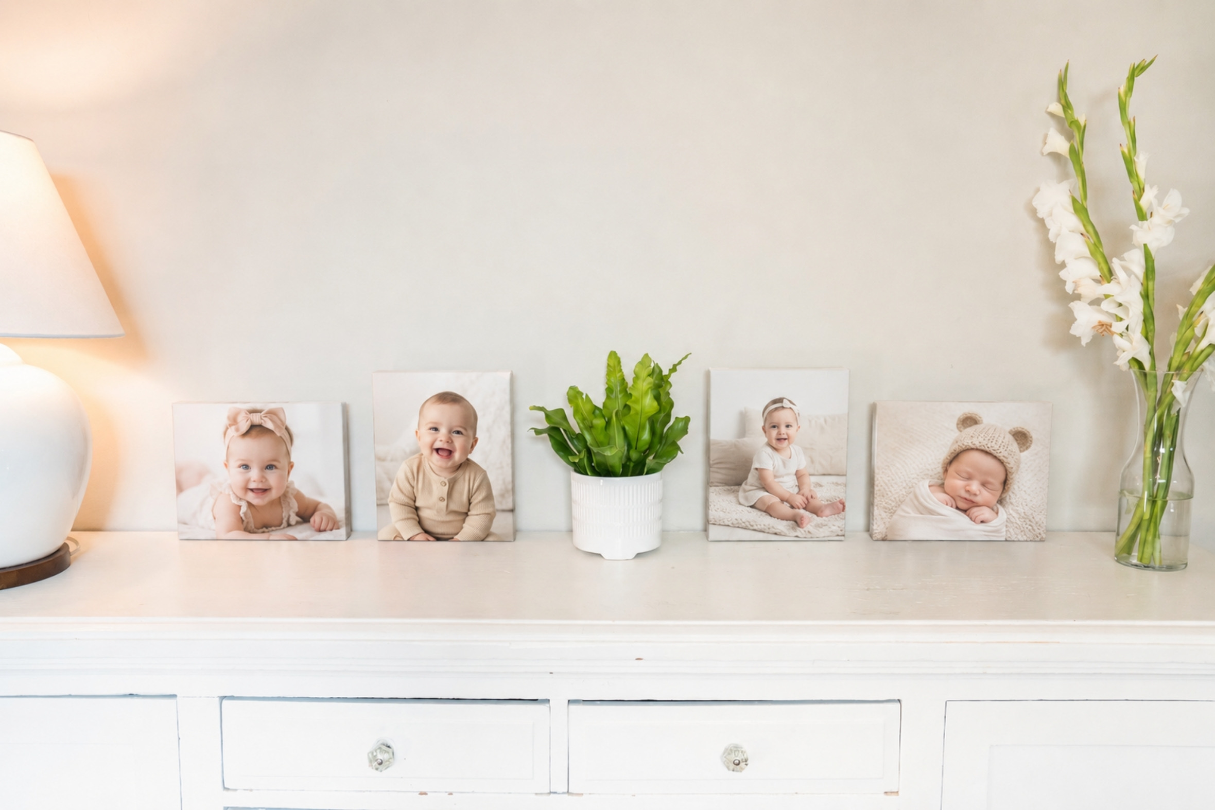 SimplePrints baby canvases displayed at different sizes on a nursery shelf