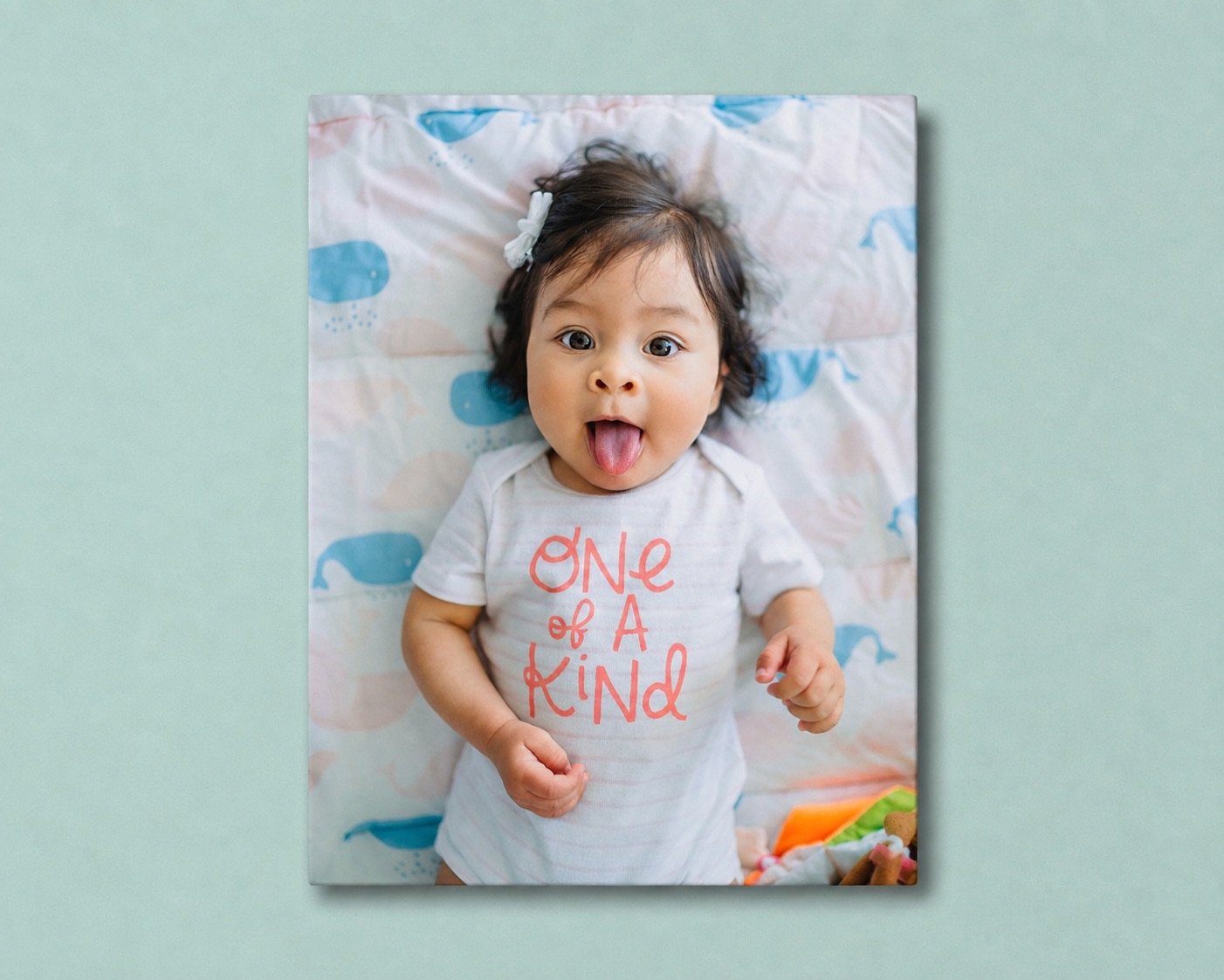 A baby canvas print on a nursery wall