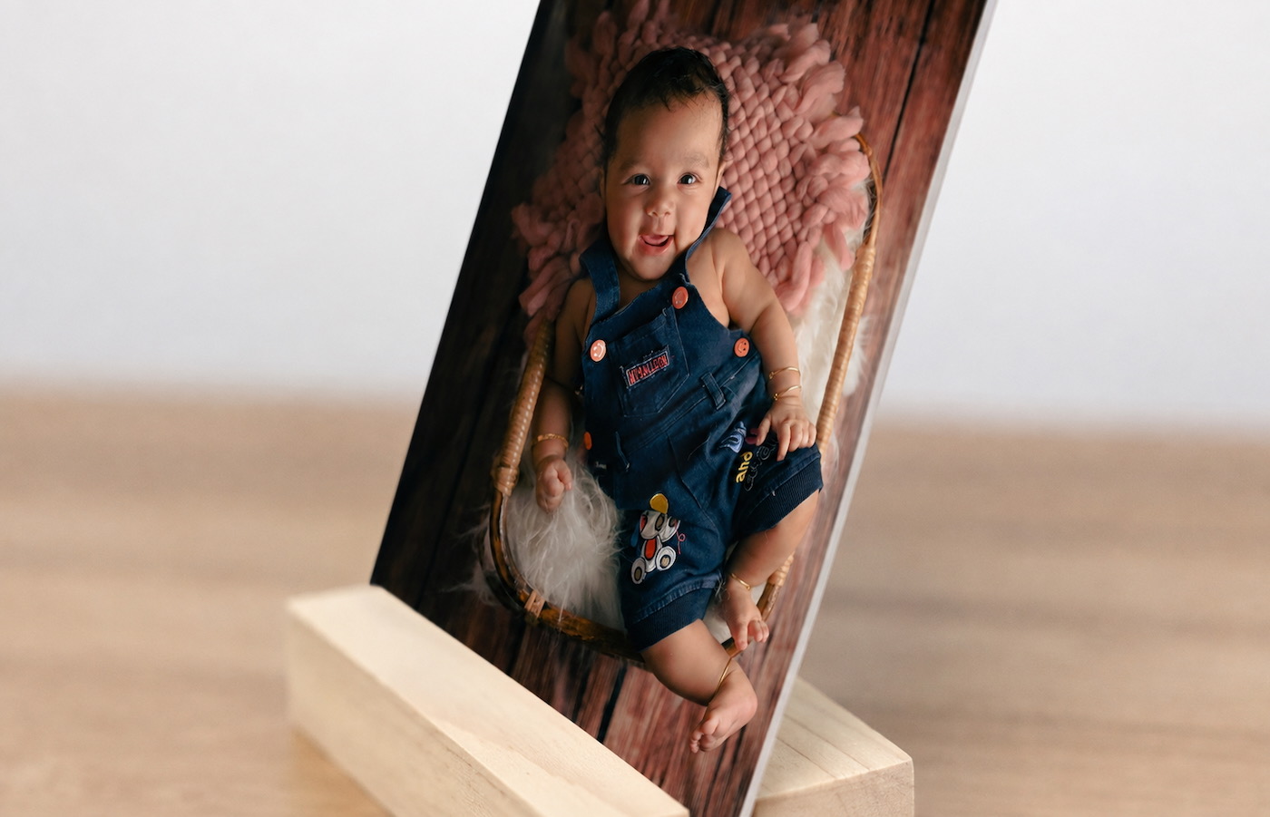 Side view of a baby desk print resting in its solid wood display stand