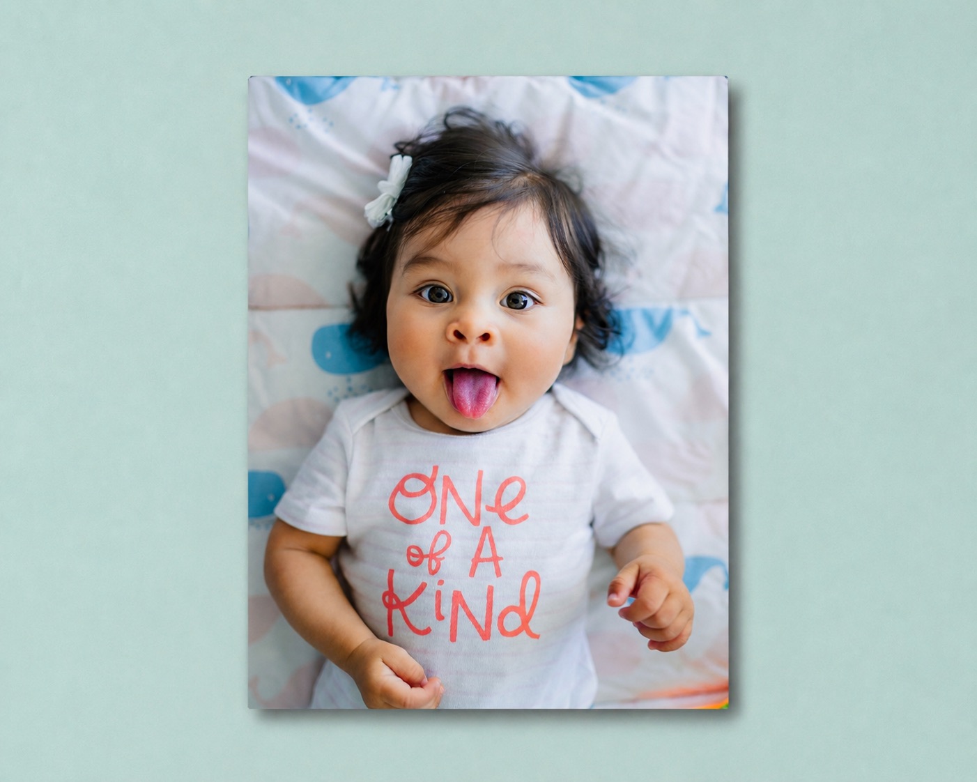 A baby metal print on a nursery wall