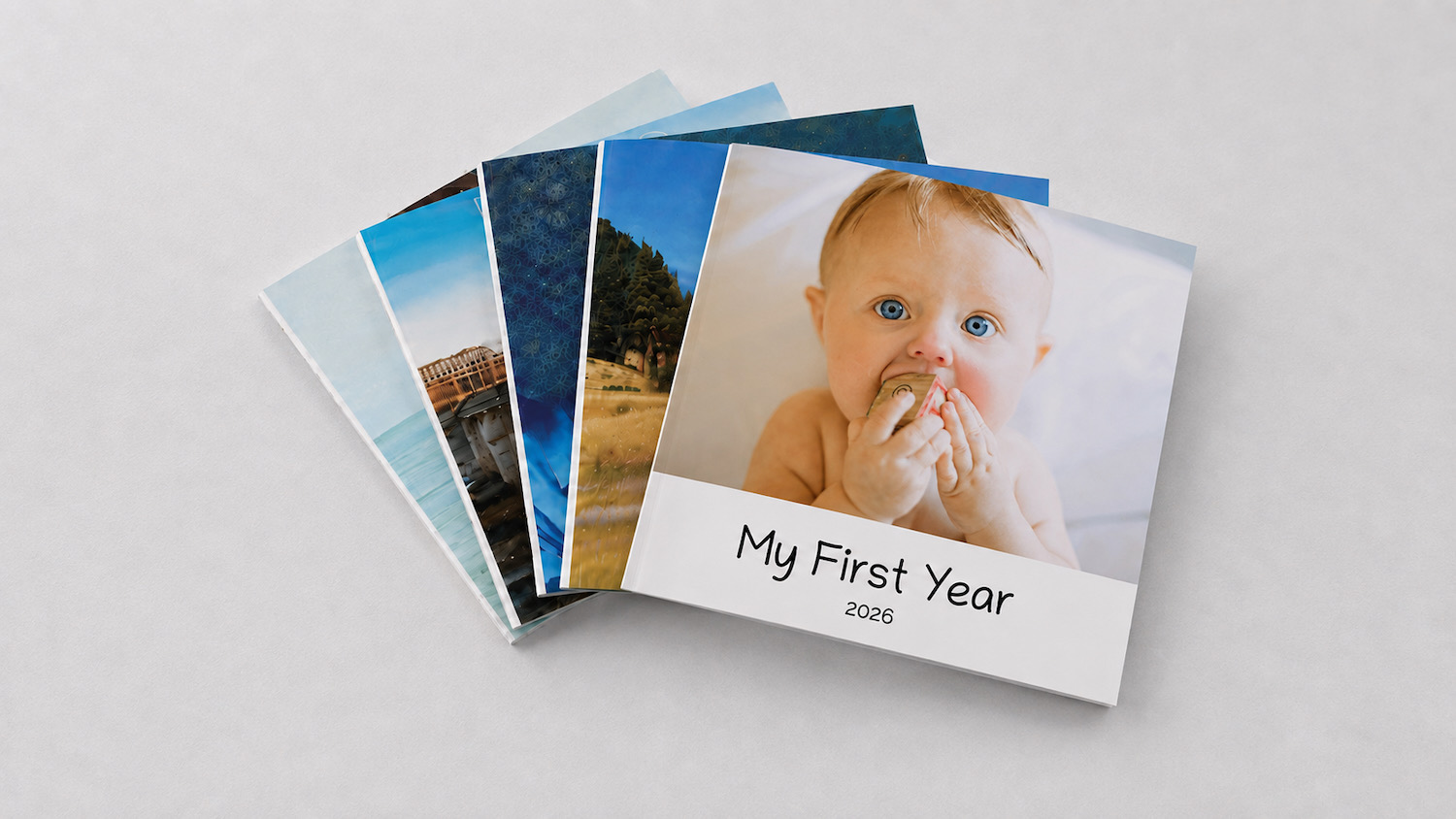 A stack of SimplePrints hardcover baby photo books