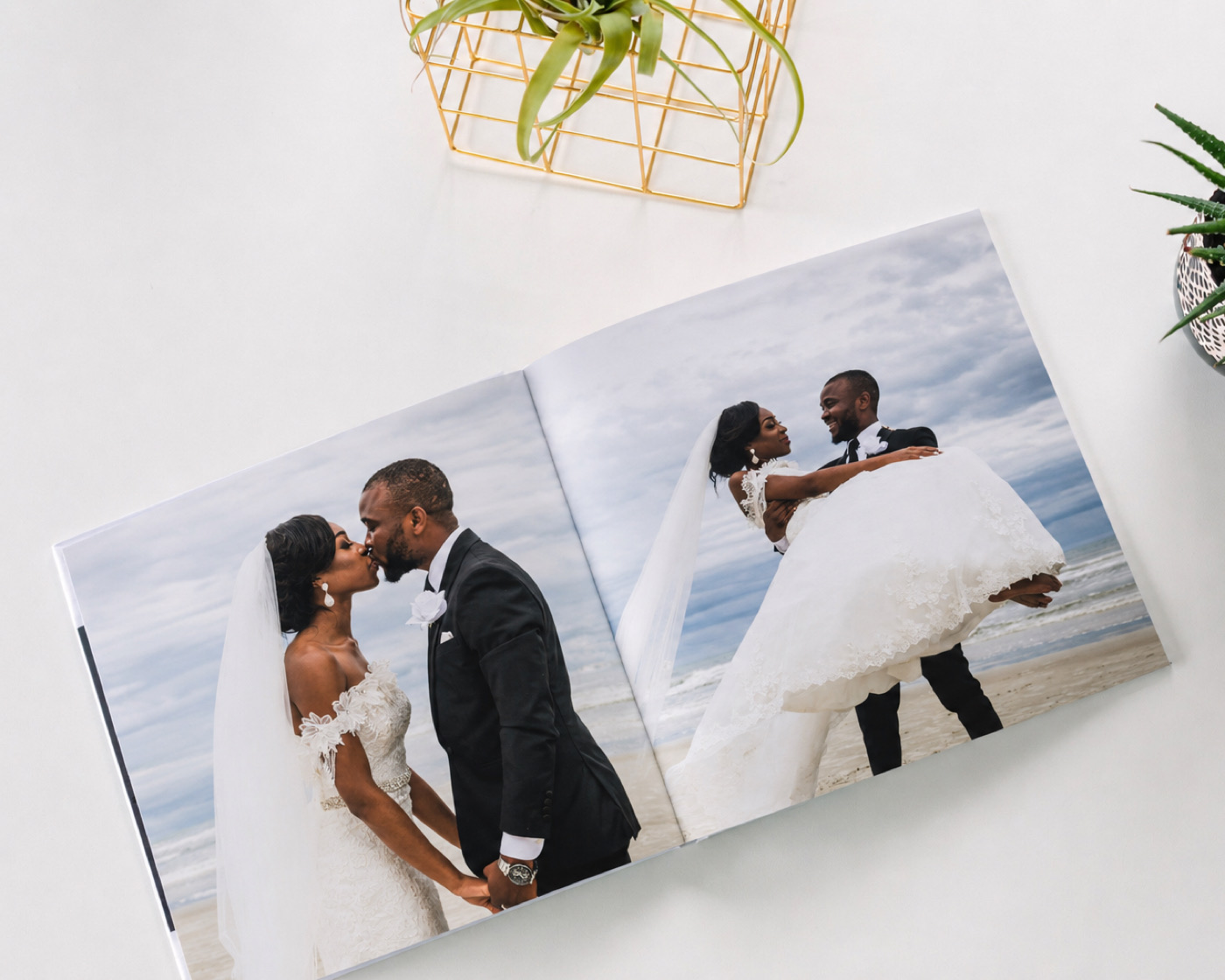 An open SimplePrints wedding photo book showing a spread of the ceremony and reception