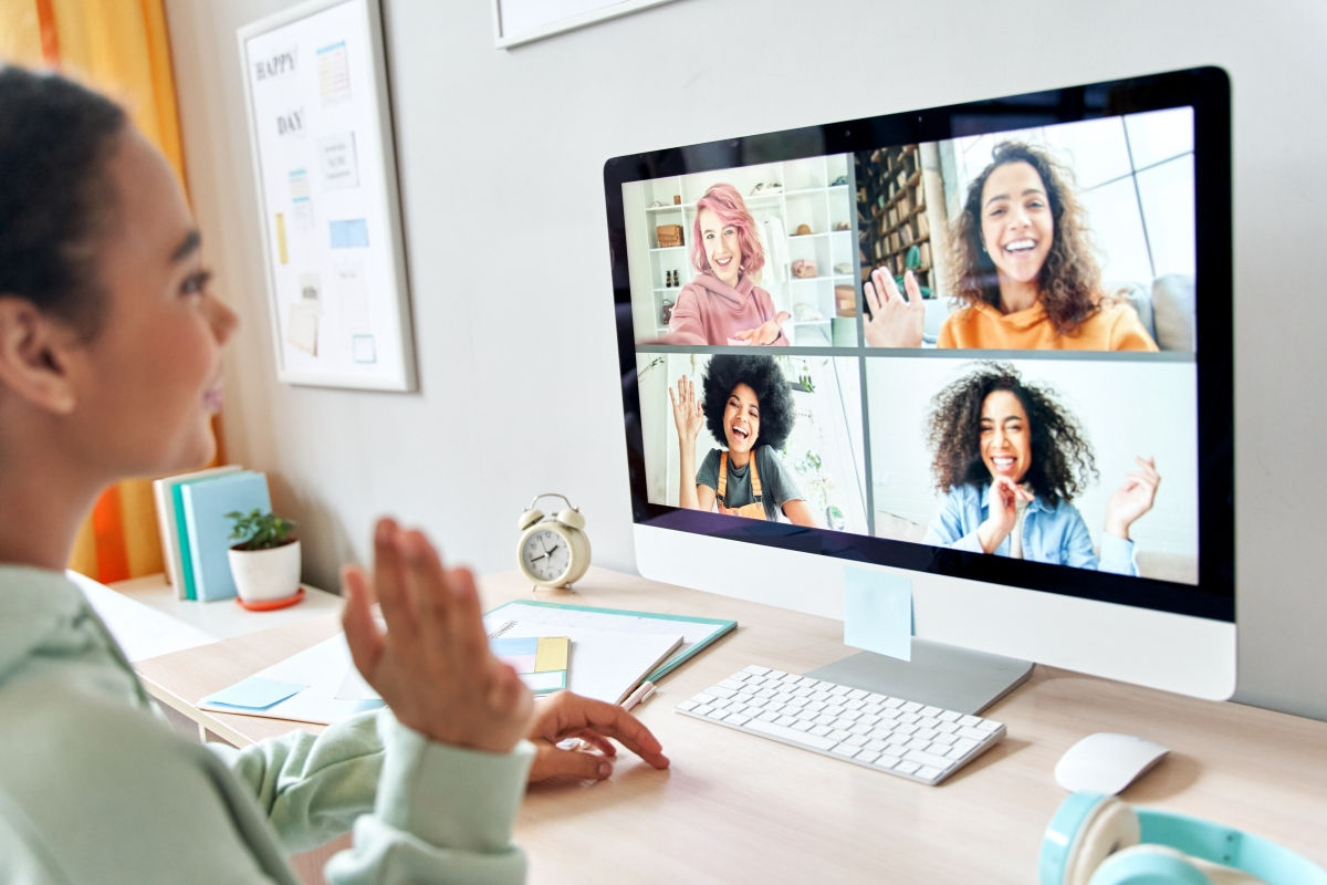a young girl on a zoom call with four other women
