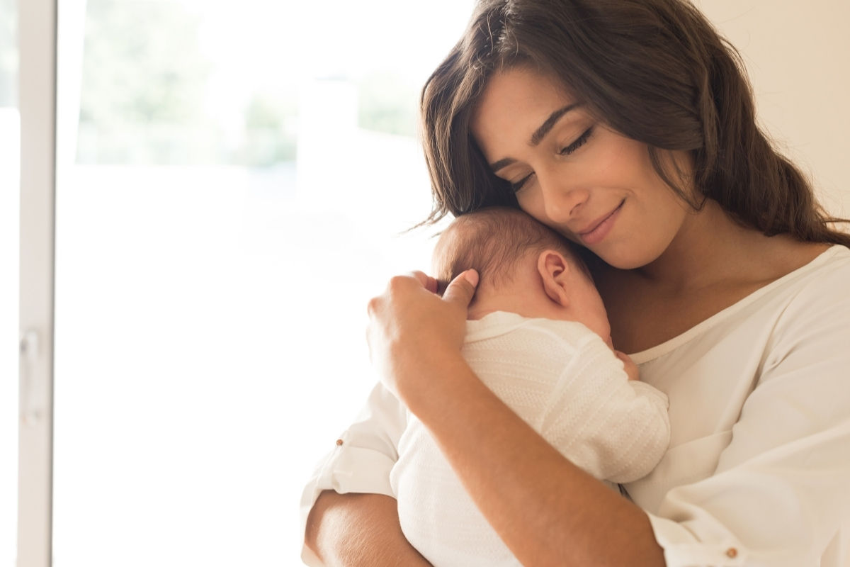A mom holding her baby close on Mother's Day.