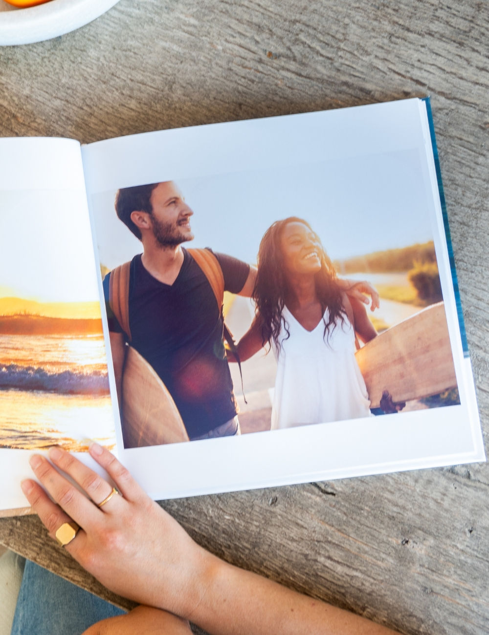 Photo book of a couple with surfboards on their honeymoon