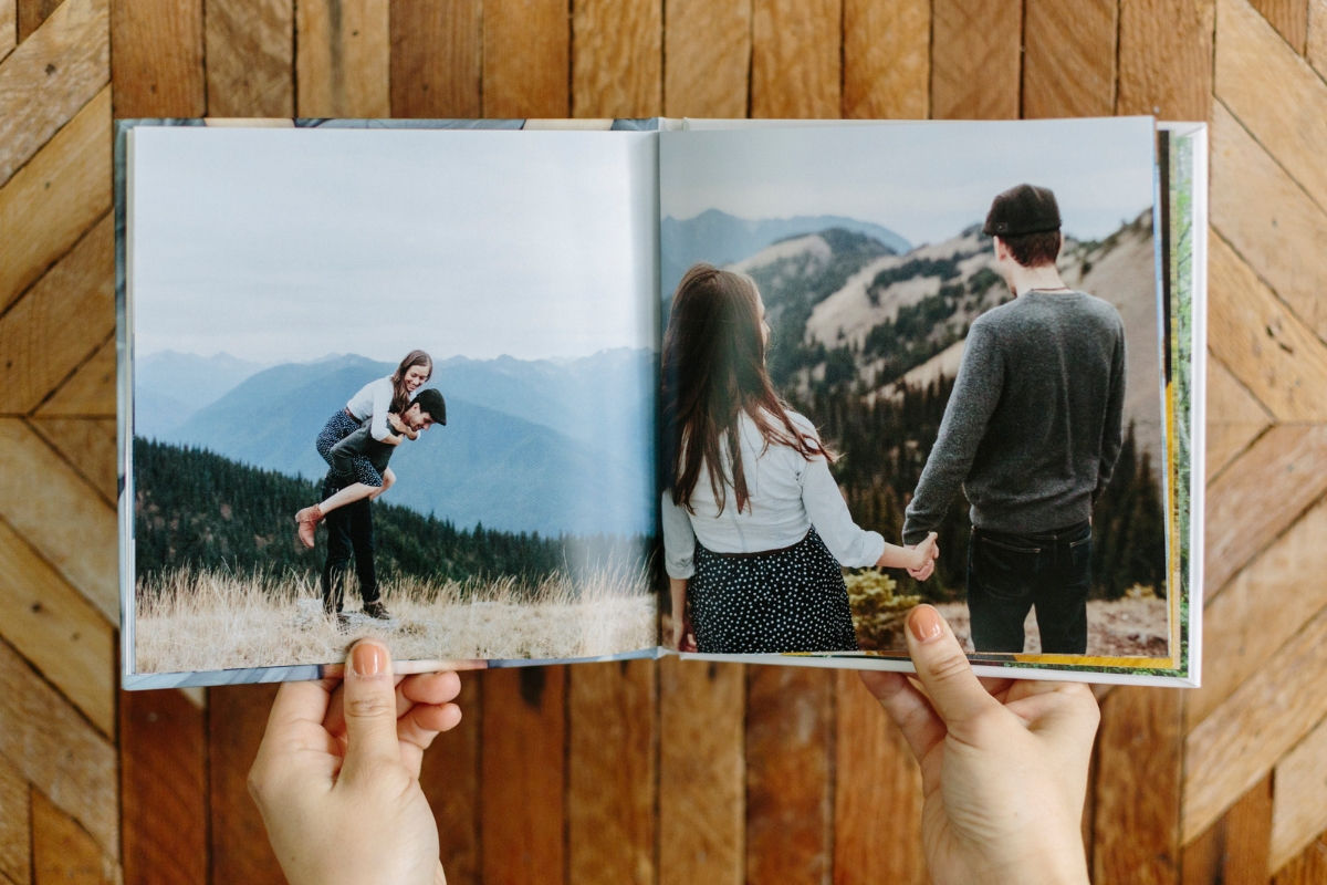 Person holding SimplePrints photo book of a couple