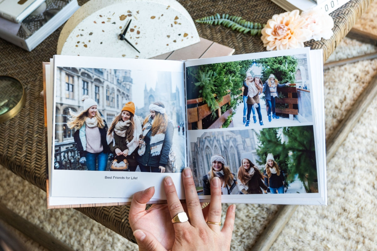 A photo book with pictures of three young ladies ice skating with a caption best friends for life.