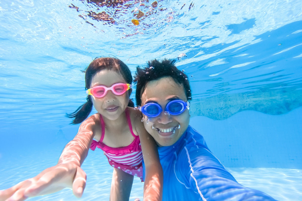 Dad and daughter taking a selfie underwater
