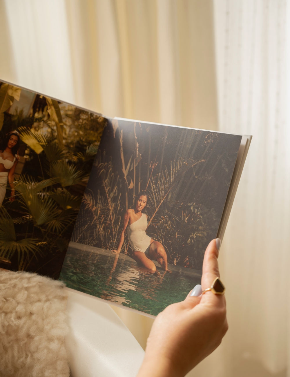 Photo book with a picture of a woman by a pool at a spa