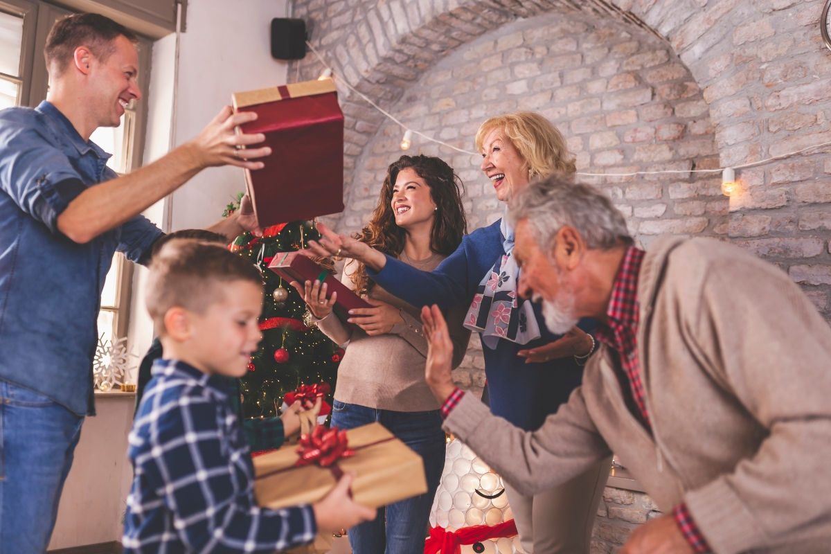A family of multiple generations giving gifts to each other for Christmas
