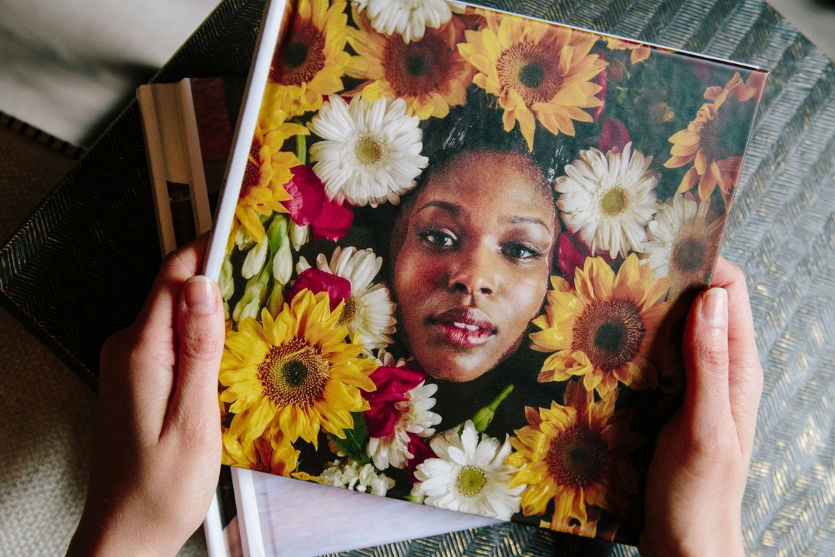 Photo book with a cover of a woman's face surrounded by flowers