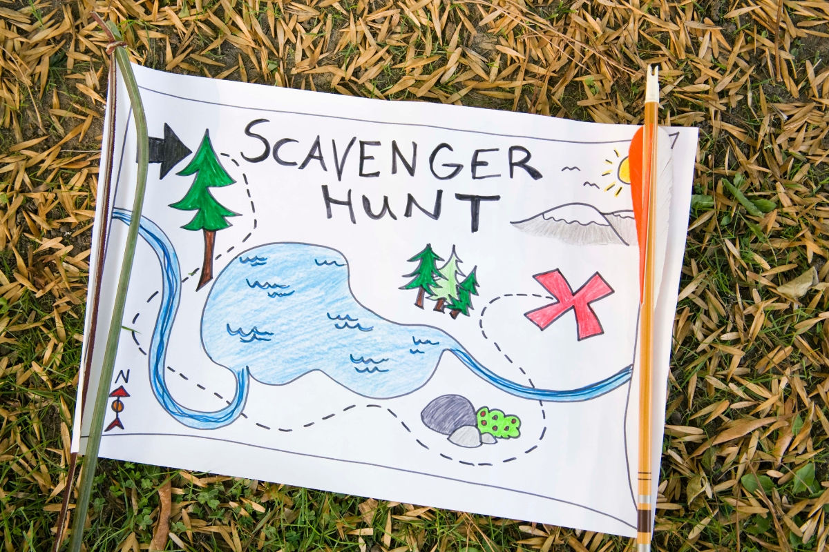 A paper scavenger hunt map laying on a patch of fallen leaves