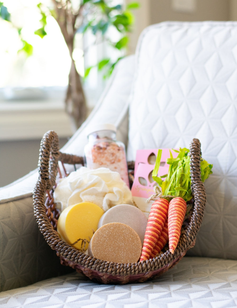 Shallow round gift basket with an assortment of soaps and scrubs