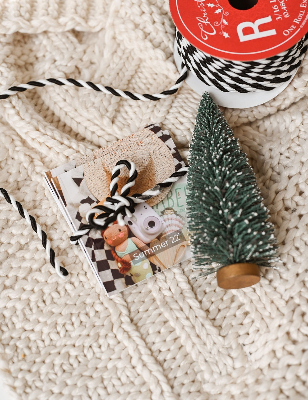 Three mini photo books of summer memories tied up to be gifted for the holidays