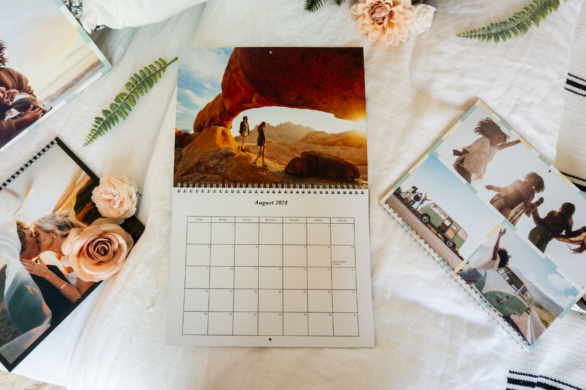 a bunch of custom calendars open with personal pictures of hikes, roadtrips and wedding photos