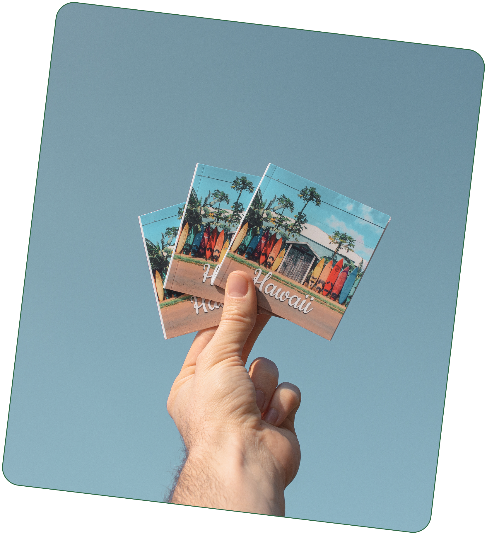 Mini photo books held up in the air