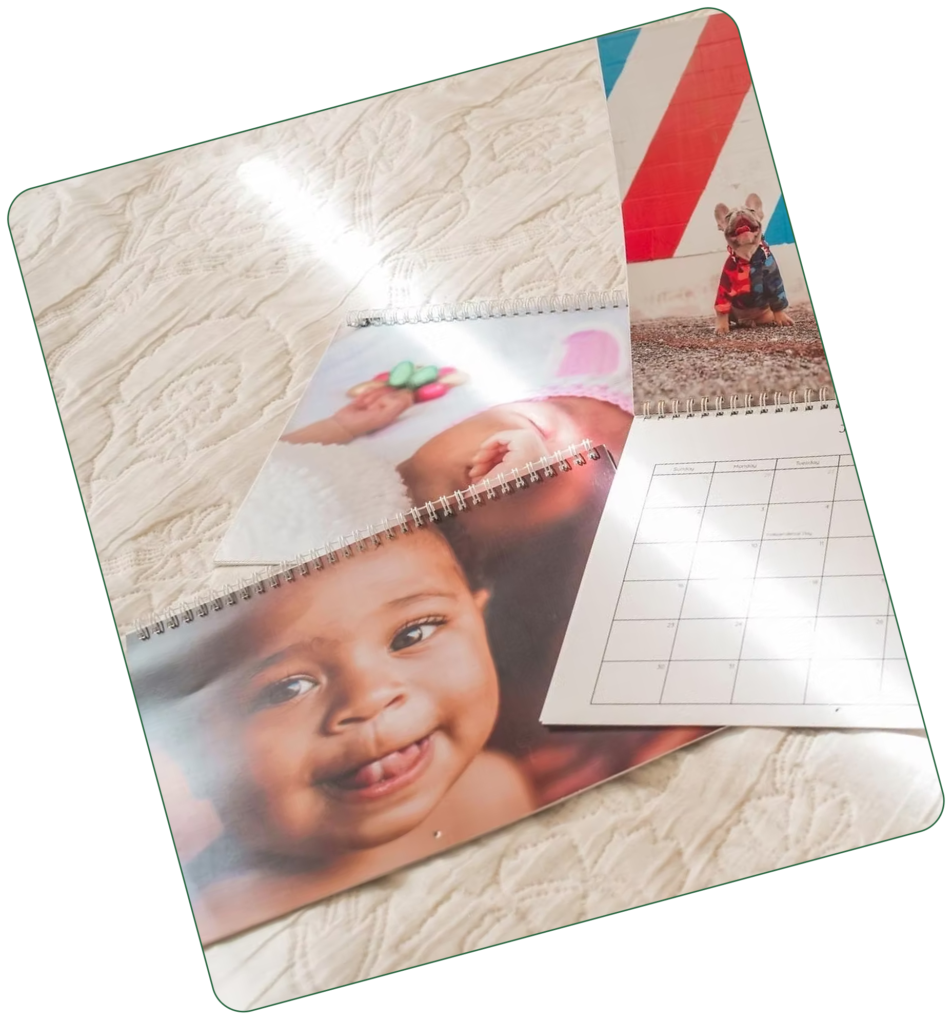 Three wall calendars laying on a bedspread
