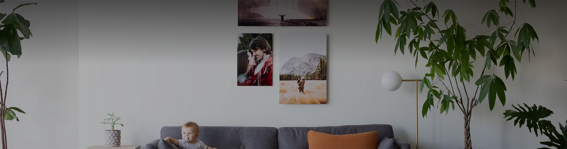 Three metal prints displayed near a toddler sitting on a couch