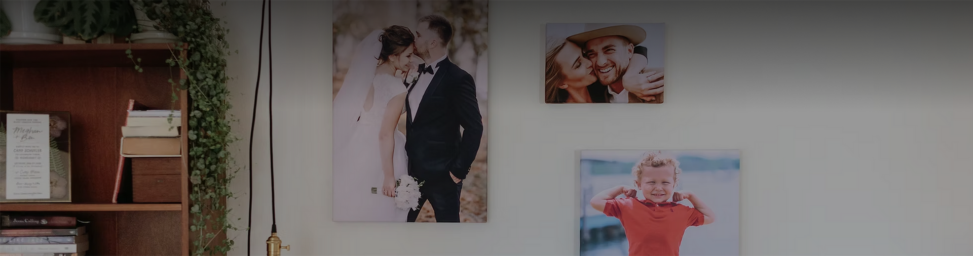 Three canvas prints hanging on a wall next to a bookshelf