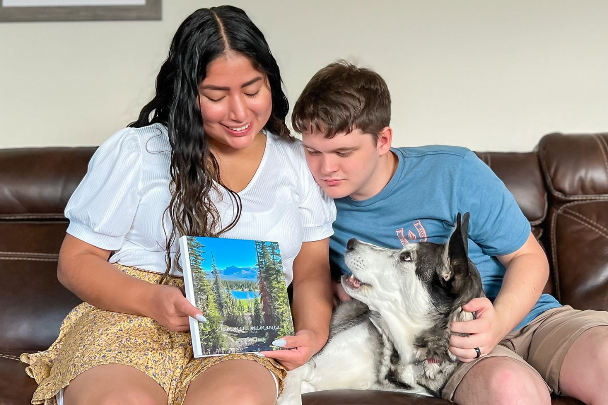 Couple looking at a SimplePrints Hardcover photo book