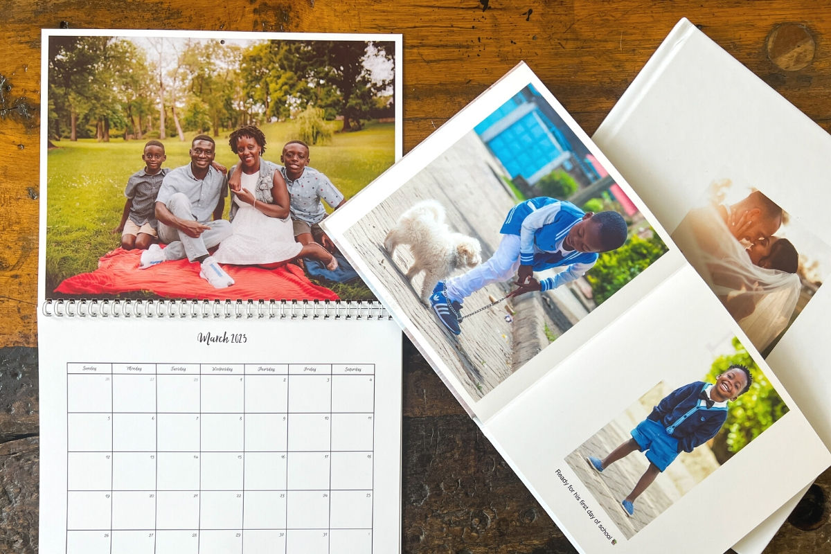 Wall calendar and two photo books on top of a wooden table