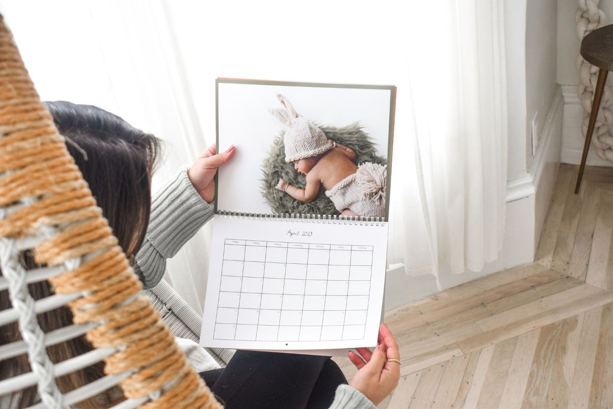 Person holding a SimplePrints Wall Calendar open