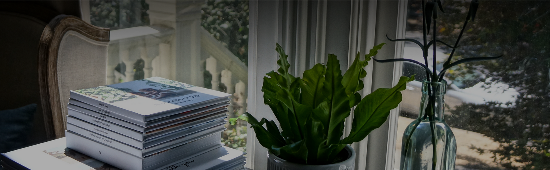 Photo books sitting in sunlight by a window